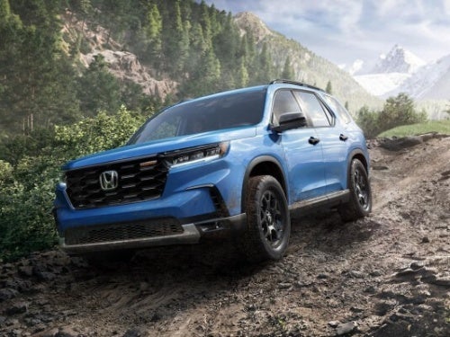 2024 Honda Pilot driving down a mountain dirt road