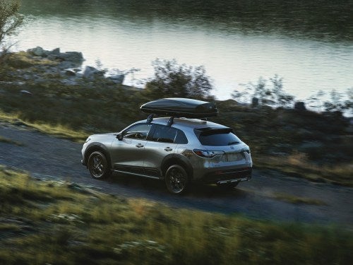 2025 Honda HR-V driving down a dirt path hauling a kayak