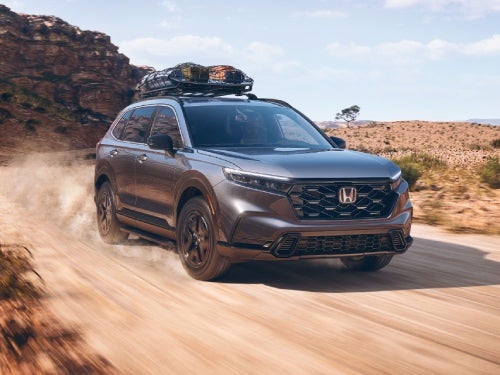 2025 Honda CR-V Hybrid driving on a dirt road